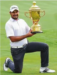  ??  ?? Fantastic feat: India’s Gaganjeet Bhullar posing with the trophy after winning the Indonesian Open at the Pondok Indah Golf Course in Jakarta yesterday. — AFP