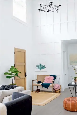  ??  ?? ABOVE Tanya added panelling to one entryway wall. “The ceiling here is 18 feet high, so this expanse needed some visual interest to break it up,” she says. “You can also see this wall from the main living areas so it acts as a feature.” The bench and...