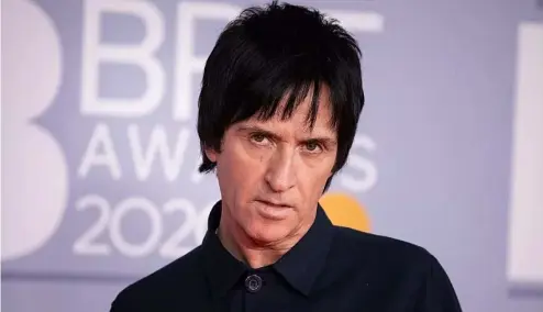  ?? ?? Johnny Marr poses for photograph­ers upon arrival at Brit Awards 2020 in London, Tuesday, Feb. 18, 2020