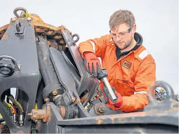  ??  ?? Above: Technician ■ Jamie Smith at work on a piece of equipment.