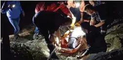  ??  ?? RESCUE MISSION: NSRI Agulhas crew rescued a dolphin stranded on rocks in Arniston using a high-angle rope system to hoist the female dolphin into a Stokes basket over the rocks, before she was released into the sea.