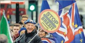  ??  ?? THE CIRCUS CONTINUES: Brexit protesters wave flags outside parliament in London on Tuesday.
AP