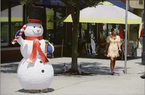  ?? H John Voorhees III / Hearst Connecticu­t Media ?? A snowman is setup for New Milford’s Christmas in July on Friday in New Milford.