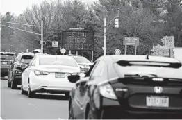  ?? MIKE COPPOLA GETTY IMAGES ?? Cars are diverted from entering a new drive-thru COVID-19 testing facility Friday in Paramus, N.J. The facility reached capacity and closed at noon.