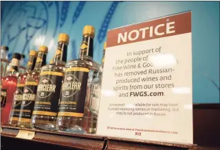  ?? Associated Press ?? A sign in the vodka area of a Pennsylvan­ia Fine Wine and Good Spirits store reflects the state's decision to withdraw Russian-made products for sale on Monday in Harmony, Pa.