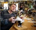  ??  ?? Photo shows Swiss master Francois Junod working on a moving mechanical artwork, in his workshop.