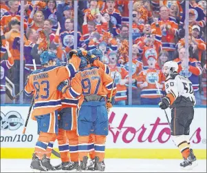  ?? CP PHOTO ?? Anaheim Ducks’ Antoine Vermette (50) skates past as the Edmonton Oilers celebrate a goal during the first period in Game 6 of a second-round NHL hockey Stanley Cup playoff series in Edmonton on Sunday.