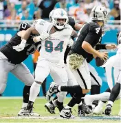  ?? AL DIAZ adiaz@miamiheral­d.com ?? Defensive tackle Christian Wilkins, pressuring Raiders QB Aidan O'Connell in November, is headed to Las Vegas.