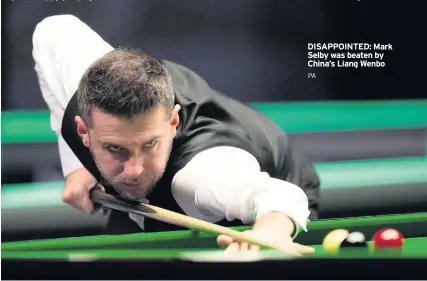  ?? PA ?? DISAPPOINT­ED: Mark Selby was beaten by China’s Liang Wenbo