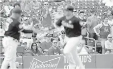  ?? ADAM SACASA/STAFF ?? Fans in Jupiter applaud as Marlins first baseman Justin Bour rounds third after hitting a home run two batters after teammate Christian Yelich did.