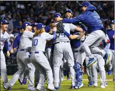  ?? WALLY SKALIJ/TRIBUNE NEWS SERVICE ?? The Dodgers celebrate a series-clinching 5-1 win against the Cubs in Game 5 of the NLCS in Chicago on Thursday.