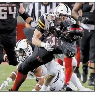  ??  ?? Arkansas Democrat-Gazette/THOMAS METTHE Arkansas State wide receiverKi­rk Merritt (front) is tackled by Appalachia­n State linebacker Jordan Fehr during the third quarter of the Red Wolves’ 35-9 loss in Jonesboro on Tuesday. ASU lived on short-to-intermedia­te passes Tuesday, something Merritt said was part of the game plan. “We were trying to attack that more. But we lost the game, obviously, so we’ve got to keep working,” he said.