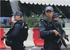  ??  ?? Above, armed police stand guard outside the St Regis hotel, where North Korean leader Kim Jong-un is staying. Right, Mike Pompeo, US Secretary of State