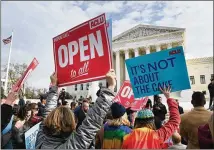  ?? OLIVIER DOULIERY / ABACA PRESS ?? Protesters gather in front of the Supreme Court last Tuesday, the day on which the court heard the case Masterpiec­e Cakeshop v. Colorado Civil Rights Commission over whether a baker can refuse to make a cake for a same-sex wedding.