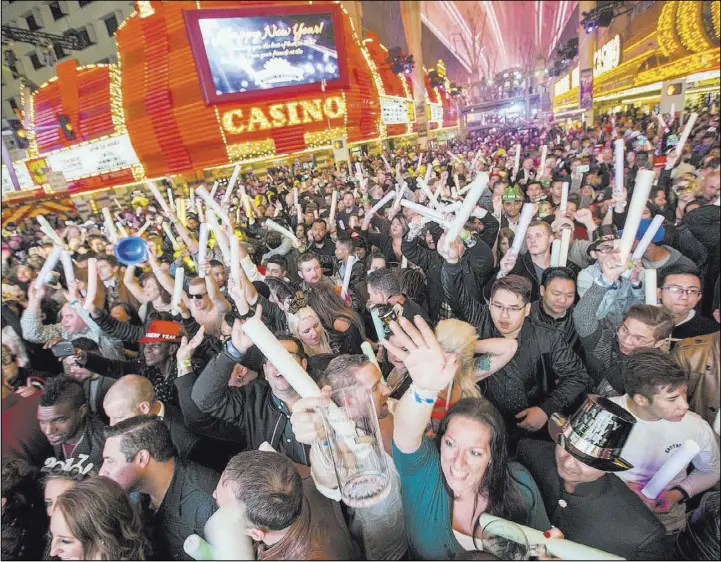  ?? LAS VEGAS REVIEW-JOURNAL FILE ?? Revelers count down Dec. 31 to the new year during America’s Party on Fremont Street. Las Vegas had a record 42.9 million visitors last year, with about 7 million from outside the U.S.