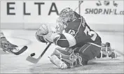  ??  ?? JONATHAN QUICK of the Kings stops a shot during the first period against the Ducks on Saturday.