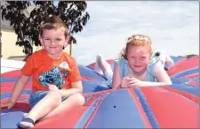  ?? JJ and Amy Collins, Limerick, enjoying the inflatable fun in the South Square at the Sneem Summer Festival. ??