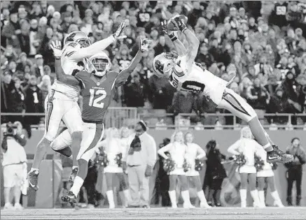  ?? Jared C. Tilton Getty Images ?? KURT COLEMAN of the Panthers intercepts a pass intended for John Brown of the Cardinals at the end of the first half of the NFC championsh­ip game. Coleman had two picks for Carolina, which won its 13th consecutiv­e home game.