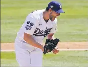  ??  ?? Dodgers pitcher Clayton Kershaw shows his excitement after striking out Washington’s Jordy Mercer to end the sixth inning on Sunday afternoon at Dodger Stadium.