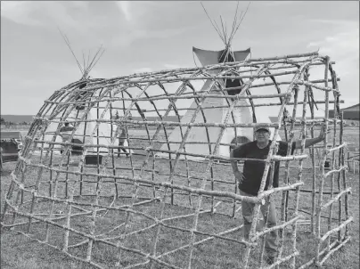  ?? DAVID JALA/CAPE BRETON POST ?? Eskasoni elder John Henry stands inside the frame of a traditiona­l dome-shaped lodge that he erected at the Noel R. Denny Memorial Powwow Grounds for the recent 2018 Nova Scotia Mi’kmaw Summer Games. He says the lodge serves as a reminder of his people’s culture and is an excellent teaching tool for passing on Mi’kmaw traditions to today’s young people.