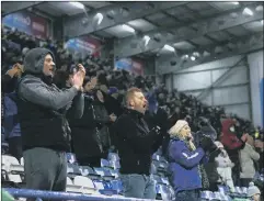  ?? Picture: Joe Pepler ?? GOOD TO BE BACK Pompey fans celebrate Jack Whatmough’s goal against Peterborou­gh United on Saturday.