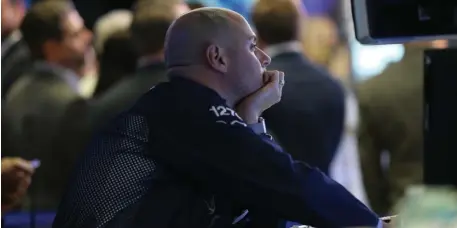  ?? GETTY IMAGES ?? GOING, GOING, GONE: Traders work on the floor of the New York Stock Exchange yesterday, when the Dow Jones industrial average fell more than 500 points as investors remain concerned about a possible trade war between China and America.