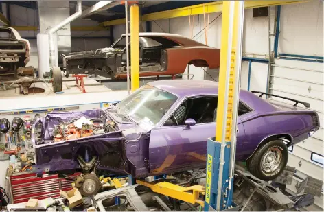  ?? CLAYTON SEAMS/DRIVING ?? Jeff Cabot’s restoratio­n shop specialize­s in Mopar muscle cars — and includes runs and paint drips the cars had when new.