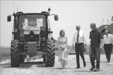  ?? ANDREW HARNIK/AP ?? PRESIDENT JOE BIDEN WALKS WITH O’CONNOR FARMS OWNERS Jeff O’Connor and Gina O’Connor (left) at the farm Wednesday in Kankakee, Ill. Agricultur­e Secretary Tom Vilsack walks at right. Biden visited the farm to discuss food supply and prices as a result of Putin’s invasion of Ukraine.