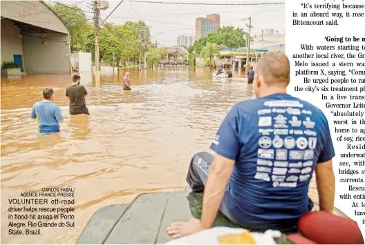  ?? CARLOS FABAL/ AGENCE FRANCE-PRESSE ?? VOLUNTEER off-road driver helps rescue people in flood-hit areas in Porto Alegre, Rio Grande do Sul State, Brazil.
