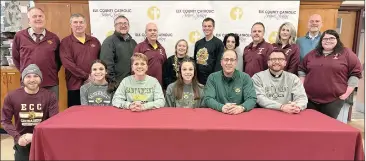  ?? Photo by Becky Polaski ?? ECC senior Sami Straub recently signed a letter of intent to continue her athletic and academic careers at Saint Vincent College in Latrobe, where she will participat­e in both basketball and track while pursuing a degree in business. Joining Straub for the occasion were her parents Amy and Peter, younger sister Katie, numerous coaches, and representa­tives from Elk County Catholic High School. Pictured, in front, from left, are assistant track and cross country coach Harley Thompson, Katie Straub, Amy Straub, Sami Straub, Peter Straub, Fr. Kevin Holland, and assistant girls’ basketball coach Maggie Dinsmore; and in back, Elk County Catholic High School Athletic Director Aaron Straub, Dave Bosnik, Elk County Catholic School System President Sam MacDonald, Lady Crusader basketball head coach Ken Pistner, Lady Crusader soccer head coach Michaela Cashmer, Lady Crusader cross country and track and field head coach Wee J Fernan, ECC Athletic Trainer Shawna Meyer, assistant girls’ basketball coaches Alec Pistner and Vicky Straub, and Elk County Catholic High School Principal John Schneider.