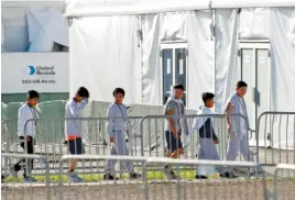  ?? AP PHOTO/WILFREDO LEE ?? Children line up in February to enter a tent at the Homestead Temporary Shelter for Unaccompan­ied Children in Homestead, Fla.