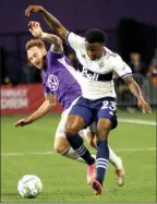  ?? The Canadian Press ?? Pacific FC’s Joshua Heard and Vancouver Whitecaps’ Javain Brown collide at Starlight Stadium in Langford, B.C., on Thursday.