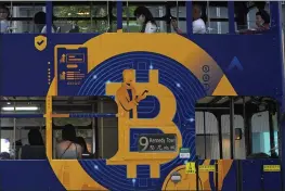  ?? KIN CHEUNG — THE ASSOCIATED PRESS FILE ?? An advertisem­ent for the cryptocurr­ency Bitcoin displayed on a tram in Hong Kong.