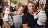  ?? AP ?? David Warner and wife Candice with their children Ivy Mae and Indy Rae arrive at Sydney Airport after the scandal. —