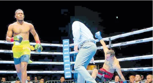  ?? CONTRIBUTE­D ?? Jerone Ennis (left) walks back to his corner after knocking down Argentinia­n Marcelo Adrian Fernande in a light-heavyweigh­t boxing contest at the Pickering Casino Resort on Saturday night.