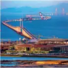  ?? by Chen Xianyao/vcg by Chen Jimin/vcg ?? June 2, 2016: The last steel tower of the Hong Kong-zhuhai-macao Bridge is installed. July 5, 2017: The eastern artificial island of the Hong Kong-zhuhai-macao Bridge project.