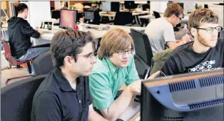  ?? AP FILE ?? In this July 29, 2011, file photo (from left) Aaron Parecki, Patrick Arlt, and Kyle Drake work in the Portland Incubator Experiment offices, in the Pearl District in Portland. The Portland Incubator Experiment, more commonly known as PIE, is ad firm...