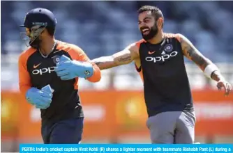  ??  ?? PERTH: India’s cricket captain Virat Kohli (R) shares a lighter moment with teammate Rishabh Pant (L) during a training session in Perth yesterday. India take on Australia in the second cricket Test match starting tomorrow in Perth. — AFP