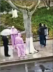  ??  ?? DISTURBING: A couple embrace on the street, left, before being bundled into an isolation unit in a truck, centre. Right: A suspected victim of the virus in Suzhou is wrestled into a clinic