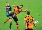  ?? GETTY IMAGES ?? Phoenix striker David Ball gets in a shot under pressure from Roar defender Jack Hingert during their A-League match on Saturday.