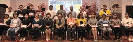  ?? ?? (Seated from fifth left) yeap and Ngiam with representa­tives of the beneficiar­ies at the handover ceremony.