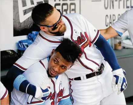  ?? PHOTOS BY CURTIS COMPTON / CCOMPTON@AJC.COM ?? Braves pitcher Julio Teheran gets a hug from Ender Inciarte after throwing six no-hit innings against the San Diego Padres on Sunday. Just off the disabled list and with a lively fastball, Teheran struck out 11 Padres.