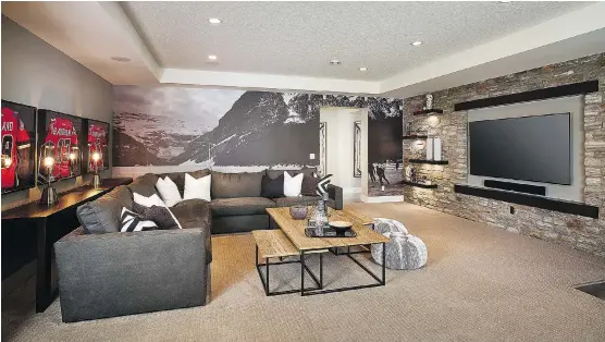  ?? CALBRIDGE HOMES ?? The media room in a recent lottery home built by Calbridge Homes features plenty of seating and a hockey themed mural display space for sports memorabili­a.