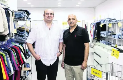  ?? / The National ?? Sibtain Malik and Waheed Nasir at the Light House used clothes outlet in Al Quoz, Dubai. Reem Mohammed