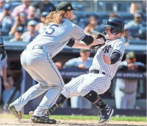  ?? WENDELL CRUZ/USA TODAY SPORTS ?? Rays pitcher Ryne Stanek tags out outfielder Clint Frazier, but the Yankees have moved ahead of Tampa Bay in the AL East.