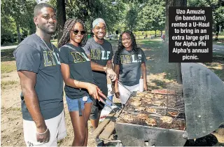  ??  ?? Uzo Amuzie (in bandana) rented a U-Haul to bring in an extra large grill for Alpha Phi Alpha’s annual picnic.