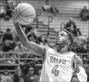  ?? MICHAEL GARD/POST-TRIBUNE PHOTOS ?? Sophomore point guard Daniel Sackey, who had 12 points and a career-high six rebounds for Valparaiso against Grand Canyon in the Paradise Jam, heads to the basket during a game against North Dakota.