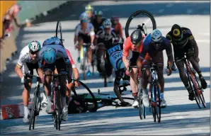  ?? AP PHOTO/CHRISTOPHE ENA ?? Germany's John Degenkolb, left background, Britain's Mark Cavendish, centre, and Britain's Ben Swift crash during the sprint of the fourth stage of the Tour de France cycling race in Vittel, France, Tuesday.