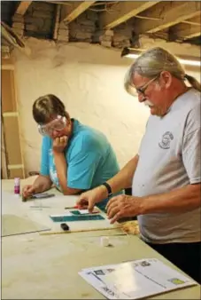  ?? PHOTOS BY MICHILEA PATTERSON — DIGITAL FIRST MEDIA ?? Stained glass art instructor Carl Altman shows his student Robin Klokis how to make, cut and shape glass during an introducto­ry class for adults at Art Fusion 19464 in Pottstown.