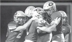  ?? DANIEL KUCIN JR./BALTIMORE SUN ?? Glenelg players celebrate Friday after notching a victory against Oakland Mills.